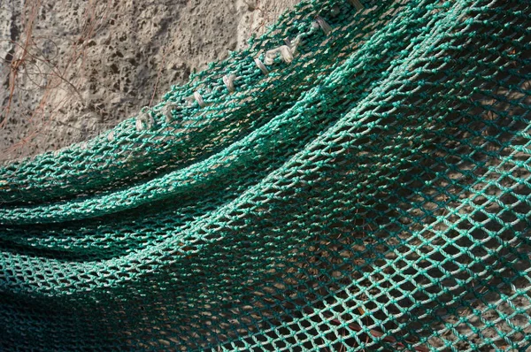 Fishing net hanging on a wall. — Stock Photo, Image