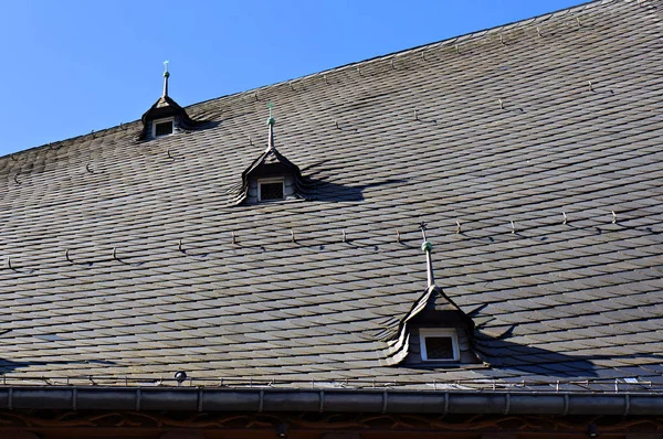 Roof of old house covered with natural black slate tiles. — Stock Photo, Image