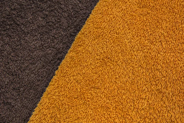 Orange and brown bath towels. Terrycloth fabric. Stock Photo