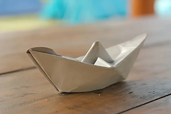 Paper boat on a table — Stock Photo, Image