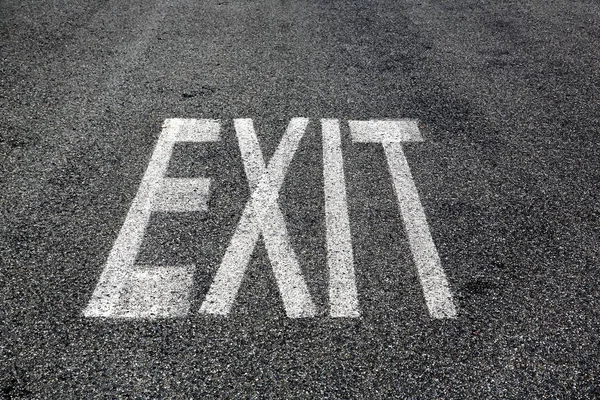 Exit sign on asphalt — Stock Photo, Image