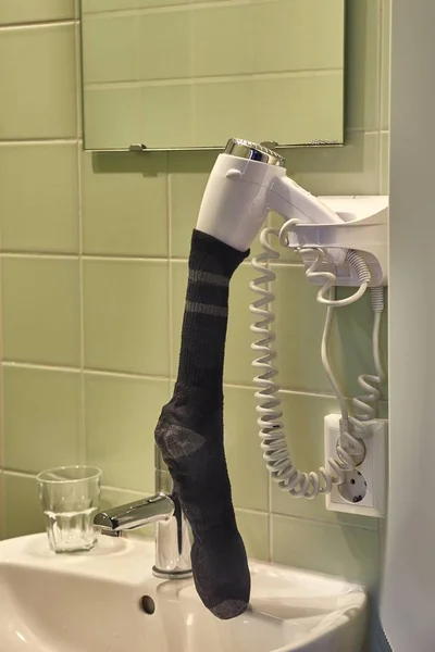 Drying sock in a hairdryer