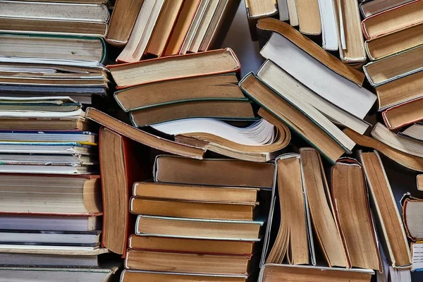 Wall of books piled up — Stock Photo, Image