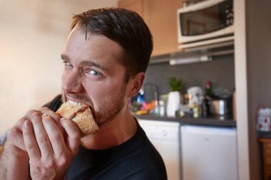 Man biting a sandwich