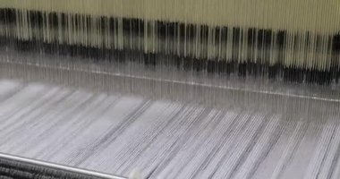 Old loom detail with white thread