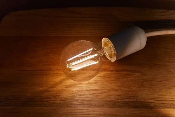 Light bulb on a table — Stock Photo, Image