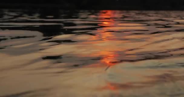 Puesta de sol sobre un lago tranquilo, reflejo de olas de agua — Vídeo de stock