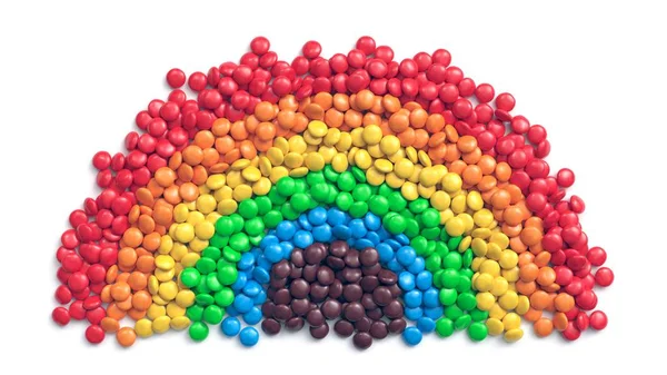 Colorful coated chocolate candies arranged as rainbow — 스톡 사진