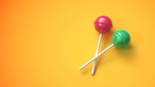 Dos piruletas dulces sobre fondo amarillo caliente — Foto de Stock