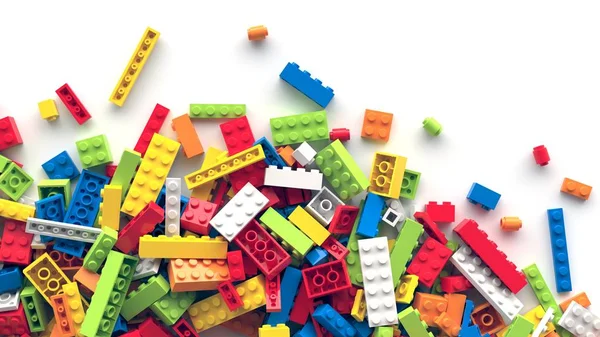 Tijolos de brinquedo coloridos espalhados no fundo branco — Fotografia de Stock
