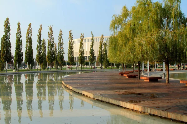 Artificial water body and recreation area surrounded by trees in — Stockfoto