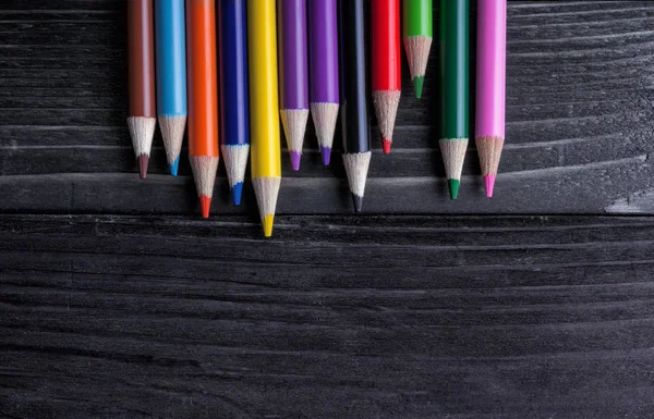 Pencils colored on black table — Stock Photo, Image