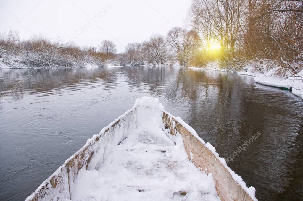 Swimming in a boat on winter river