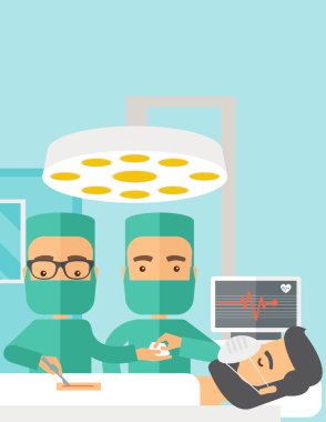 Two surgeons looking over a patient in an operating room