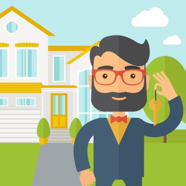 Real estate agent holding a key infront of the house