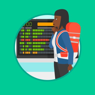 Woman looking at schedule board in the airport.