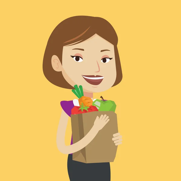 Šťastná žena držící s potravinami nákupní taška. — Stockový vektor