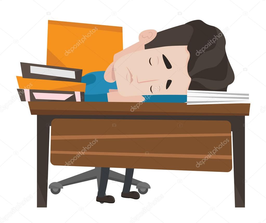 Male student sleeping at the desk with book.
