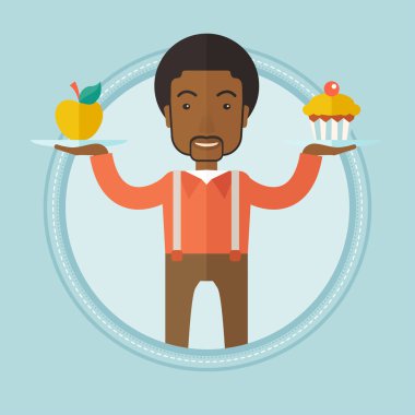 Adam elma ve cupcake arasında seçim yapma.