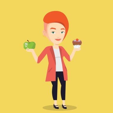 Kadın elma ve cupcake arasında seçim yapma.