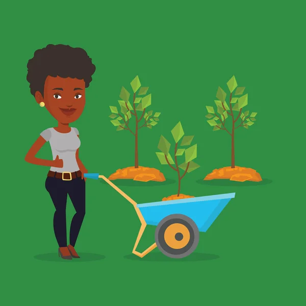 Mujer empujando carretilla con planta . — Vector de stock