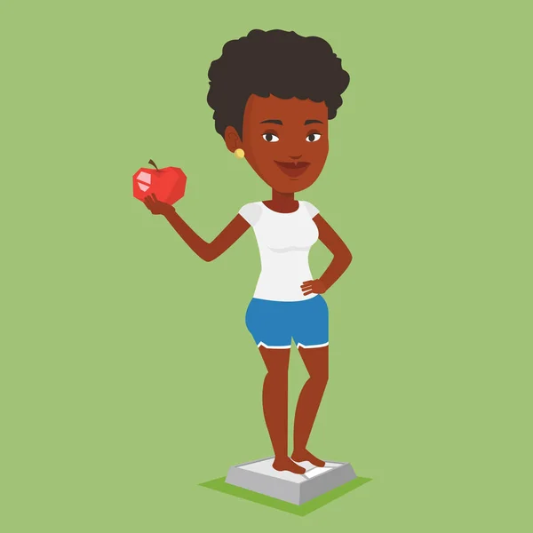 Kobieta stojąc w skali i w ręku trzyma jabłko. — Wektor stockowy