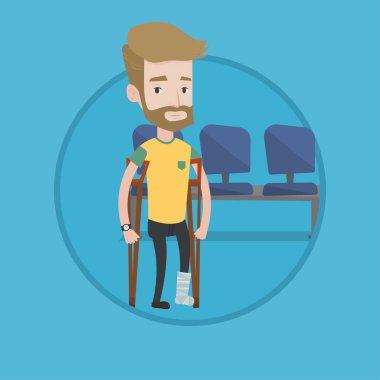 Kırık bacak ve koltuk değneği olan adam.