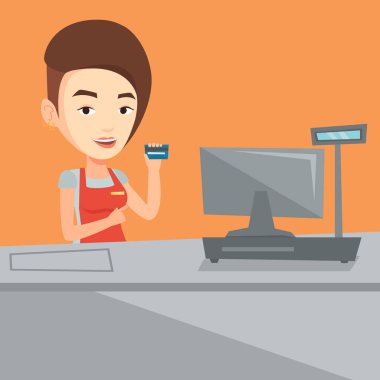 Cashier holding credit card at the checkout. clipart