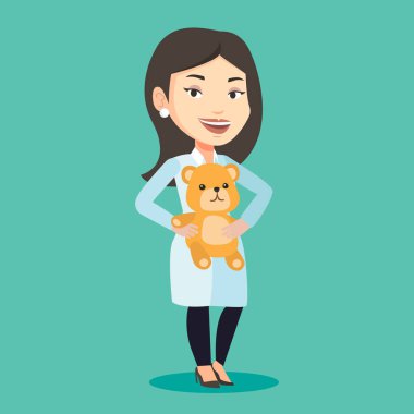 Çocuk doktoru doktor holding oyuncak ayı.