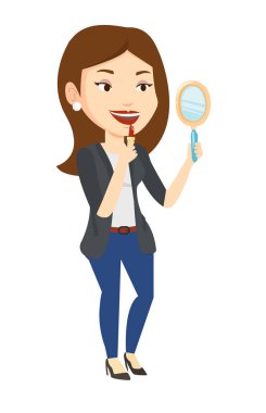 woman doing makeup and looking in mirror