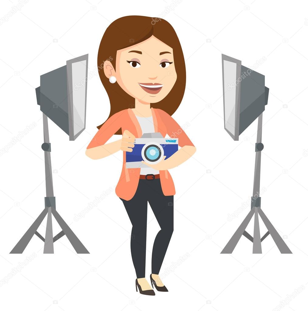 Photographer with camera in photo studio.