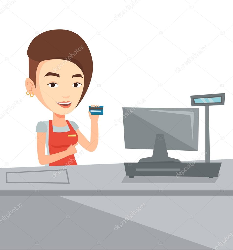 Cashier holding credit card at the checkout.