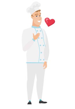 Elini göğsüne tutarak beyaz şef aşçı.