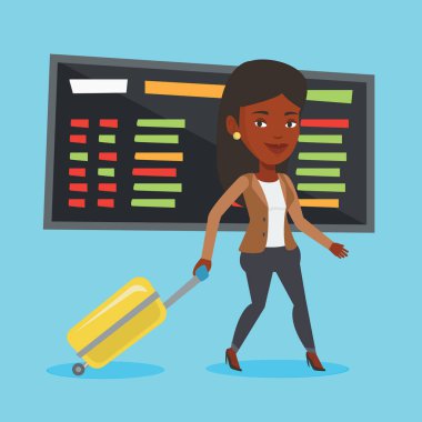 Havaalanında bavul ile yürüyen kadın.