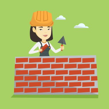 Duvarcı ustası spatula ve tuğla ile çalışma.