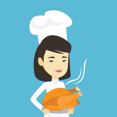 Şef Aşçı tutarak kavrulmuş tavuk.