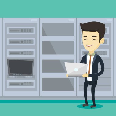 Ağ sunucu odası içinde laptop üzerinde çalışan mühendis.