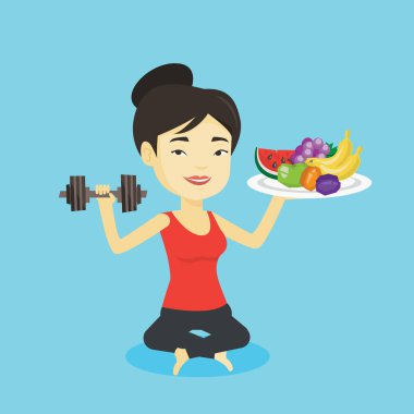 Meyve ve dumbbell ile sağlıklı kadın.