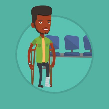 Kırık bacak ve koltuk değneği olan adam.