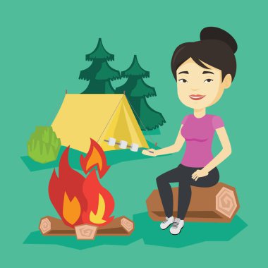 Kadın kavurma Marshmallow kamp ateşi üzerinde.