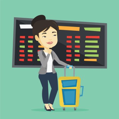 Havaalanında uçuş için bekleyen genç kadın.