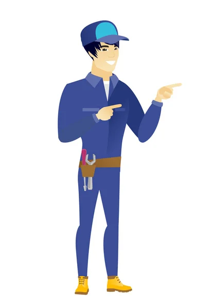 Young asian mechanic pointing to the side. — Stock Vector