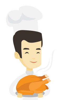 Şef Aşçı tutarak kavrulmuş tavuk.