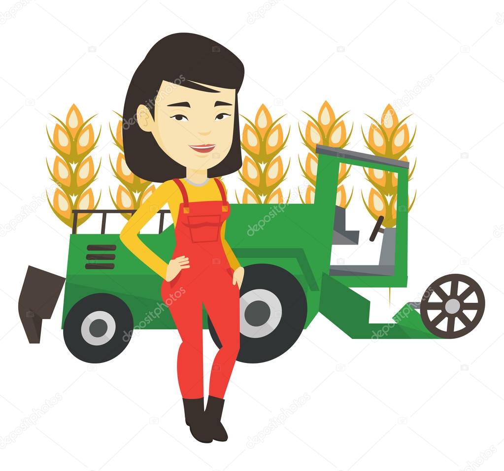 Farmer standing with combine on background.