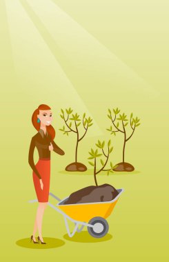 Üretim tesisi ile kadın iterek el arabası.