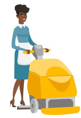 Afrikalı işçi deposu zemin temizleme makinesi ile.