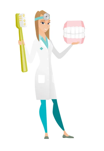 Dentista com modelo de mandíbula dental e escova de dentes . — Vetor de Stock