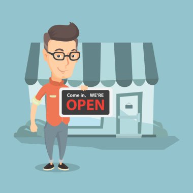 Açık tabela holding beyaz dükkan sahibi.