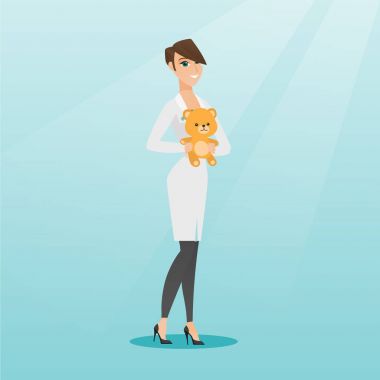 Çocuk doktoru doktor holding oyuncak ayı.