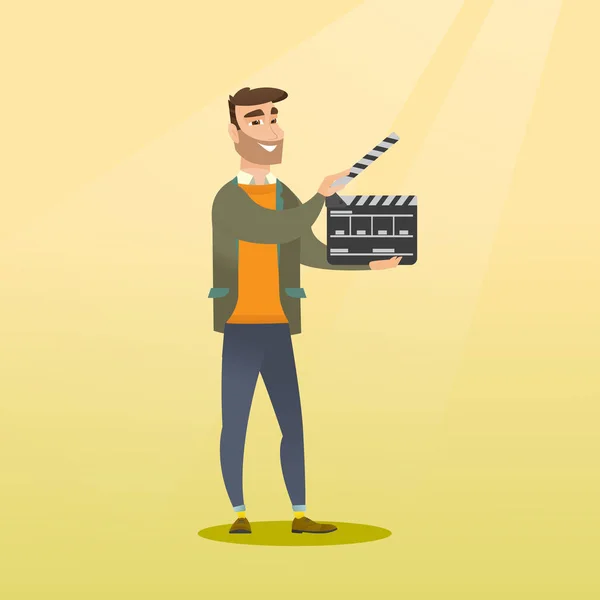 Smiling man holding an open clapperboard. — Stock Vector